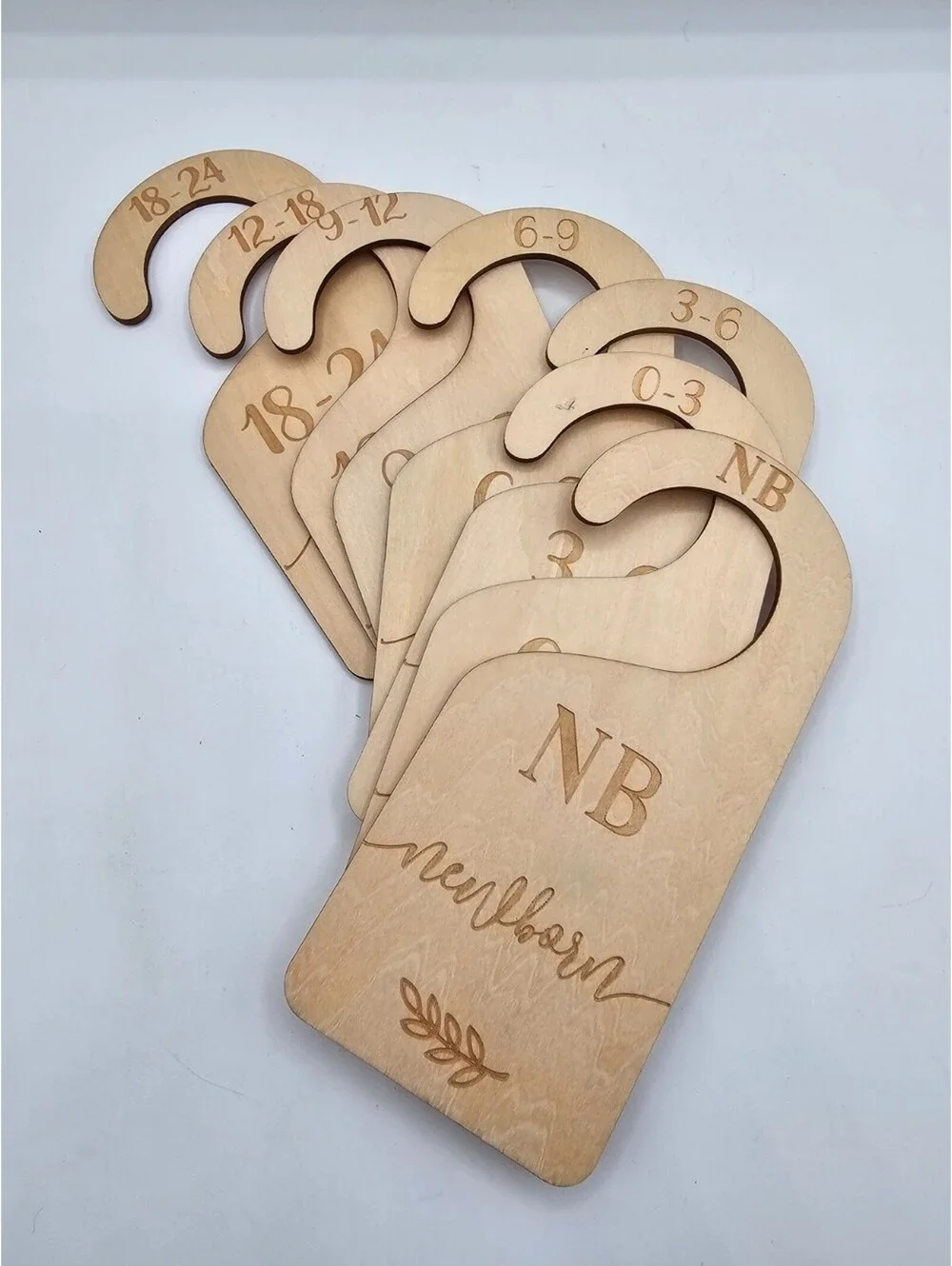Wooden baby closet dividers used for organizing baby clothes by size